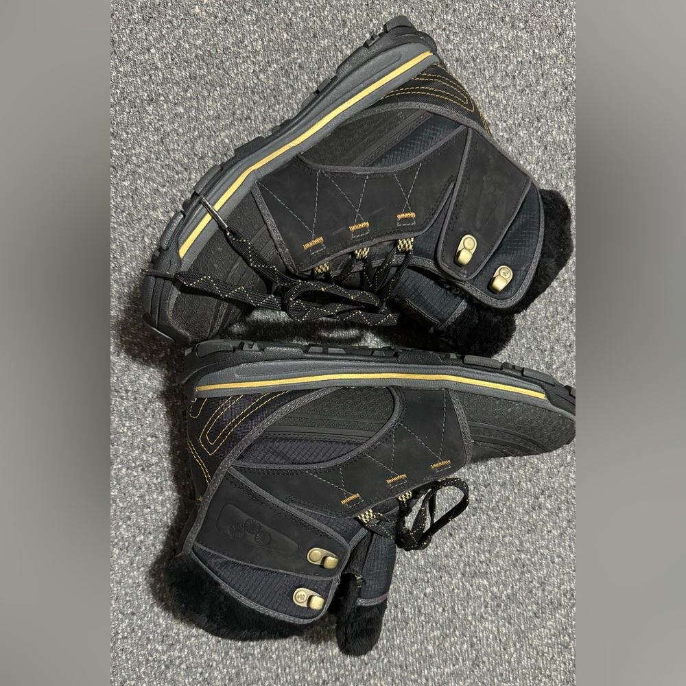Black winter boots with gold accents and a fleece lining. Lace up style